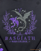 Close-up video of purple and silver Basgiath War College dragons chest embroidery on a heavy blend black sweatshirt