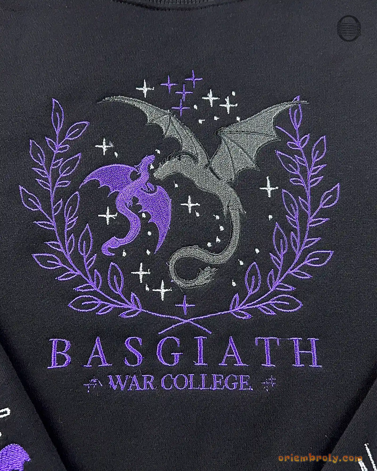 Close-up video of purple and silver Basgiath War College dragons chest embroidery on a heavy blend black sweatshirt