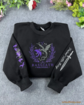 Flat lay of a black crewneck sweatshirt embroidered with Basgiath War College dragons chest emblem, dagger sleeve, and dragons sleeve