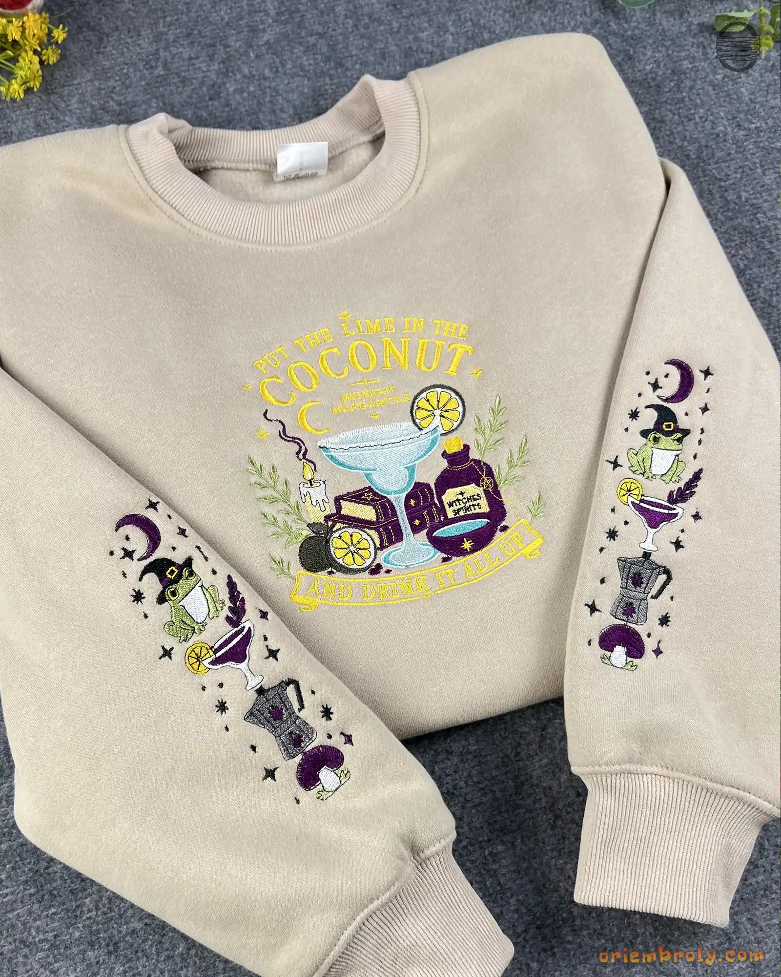 Overview flat lay of a beige Practical Magic embroidered crewneck sweatshirt with dual sleeve witchy art