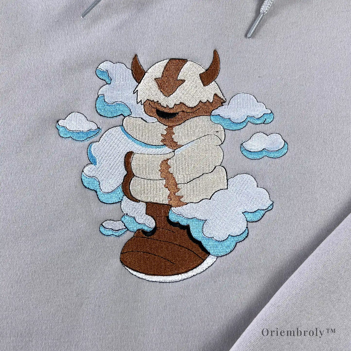 satin stitch cloud embroidery with flying bison detail