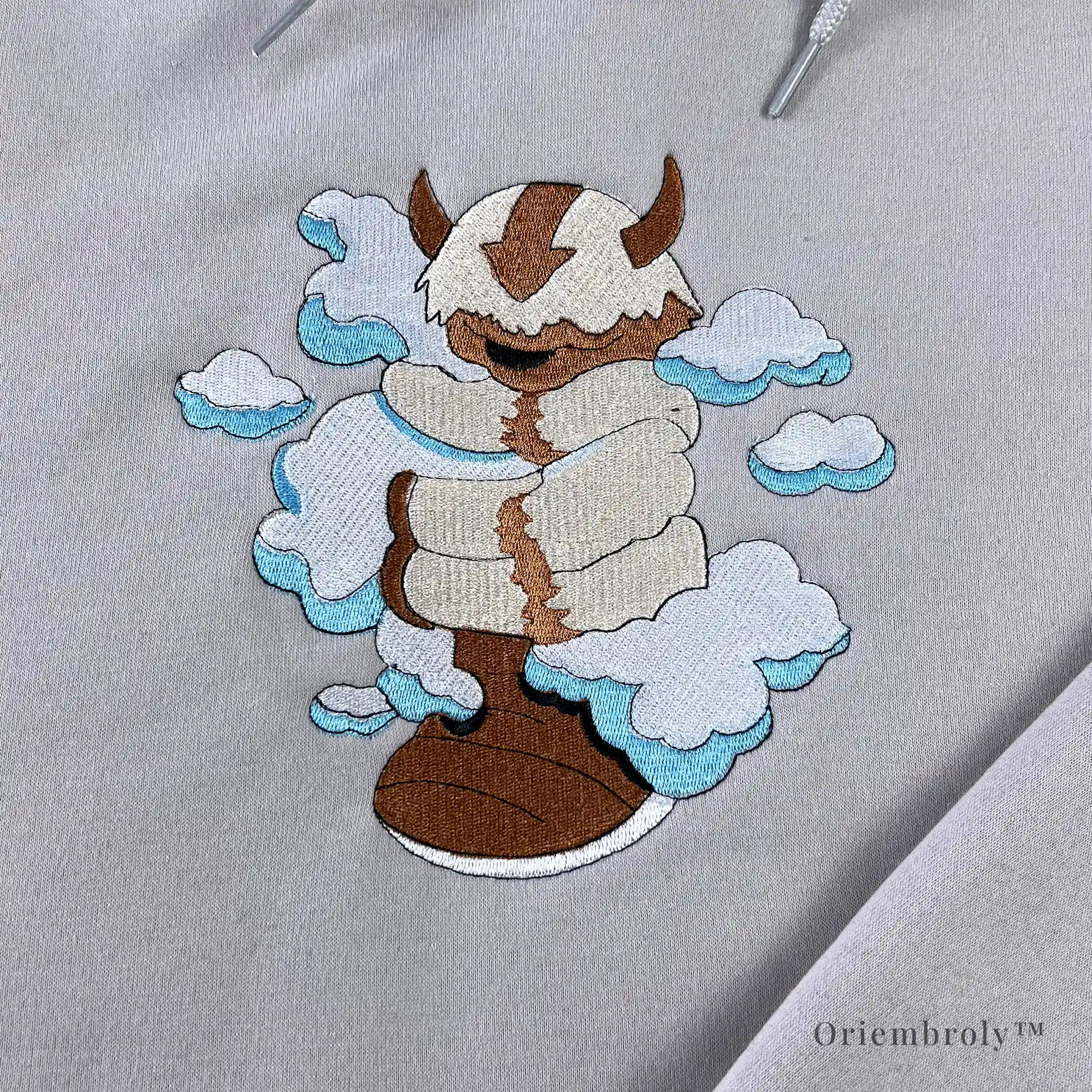 satin stitch cloud embroidery with flying bison detail