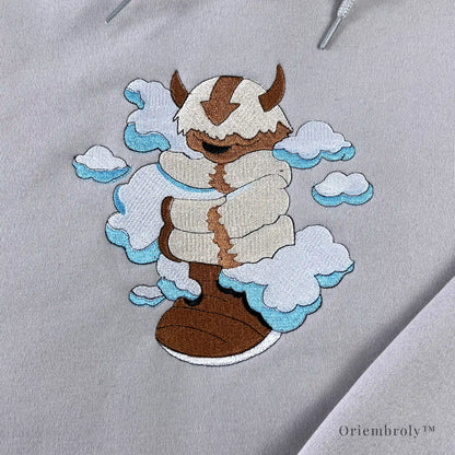 satin stitch cloud embroidery with flying bison detail