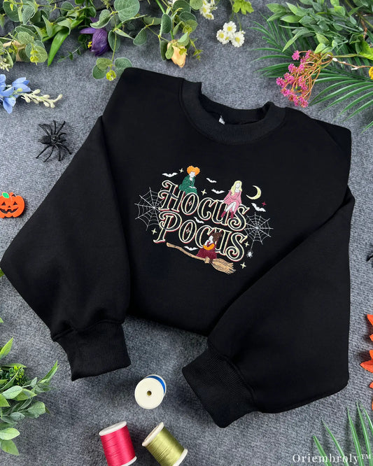Black Halloween crewneck sweatshirt embroidered with Hocus Pocus text, Sanderson sisters, and colorful sewing threads