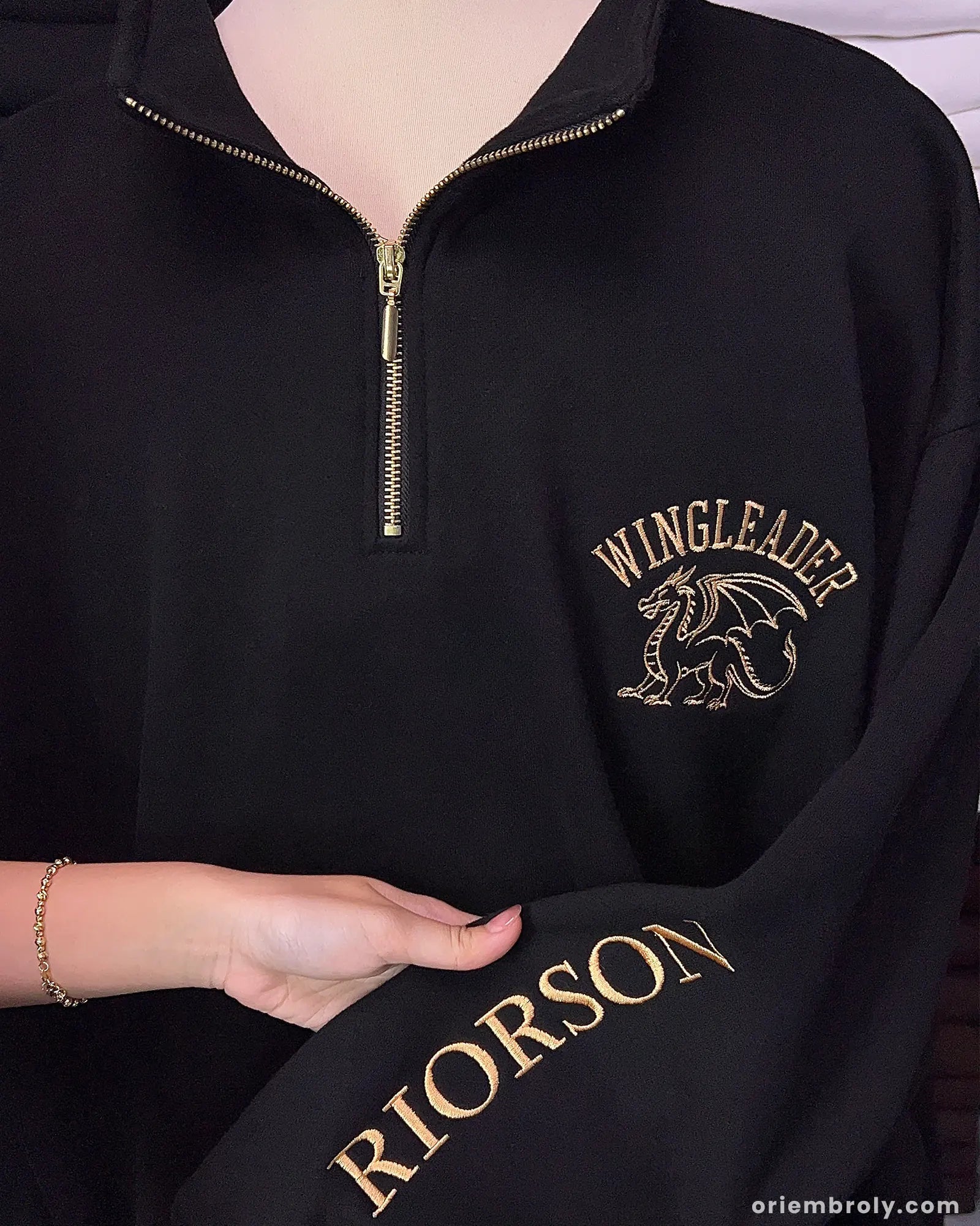 Black quarter zip featuring metallic gold dragon embroidery