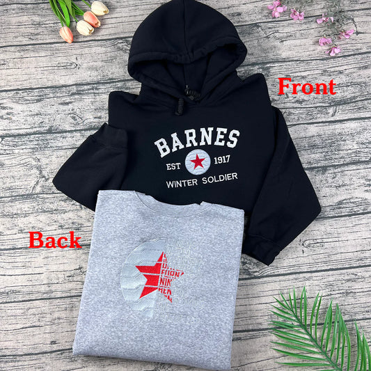Black and gray hoodies with 'Barnes' branding on a wooden surface.