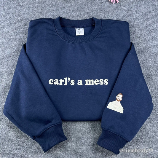 Premium navy blue crewneck sweatshirt featuring "carl’s a mess" embroidered in a vintage serif font. A funny and relatable pop culture meme shirt for fans of ironic humor and internet trends