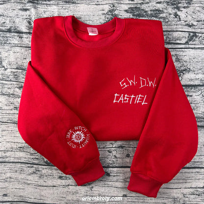 Red sweatshirt with white text on a wooden surface