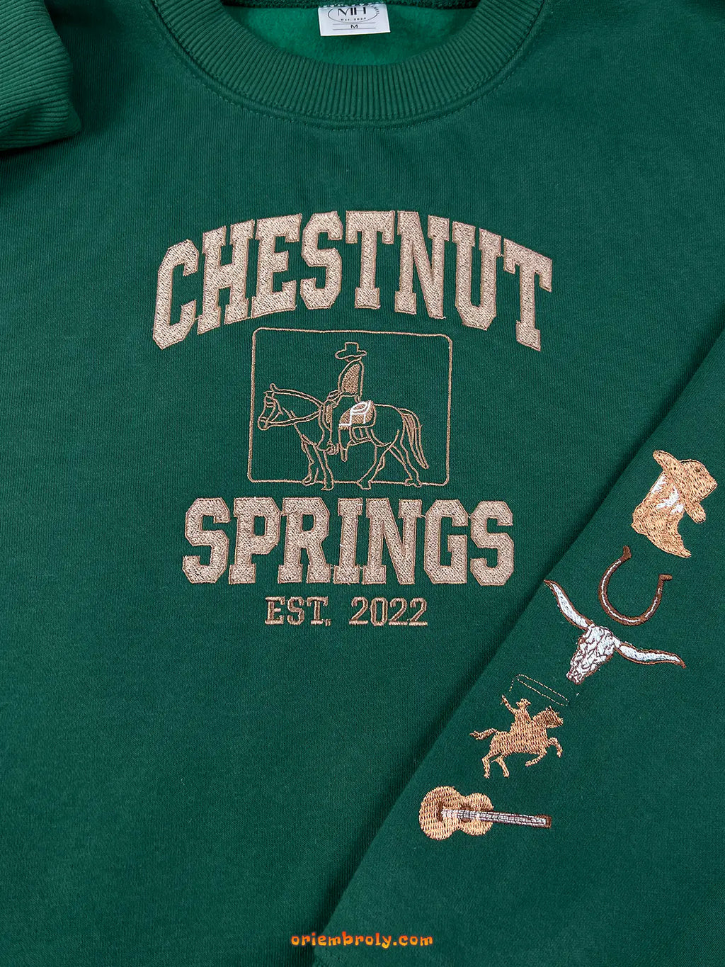 Green sweatshirt with 'Chestnut Springs' text and horse graphics on a green background