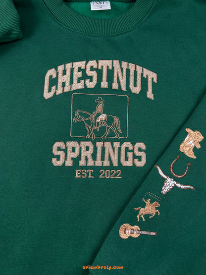 Green sweatshirt with 'Chestnut Springs' text and horse graphics on a green background
