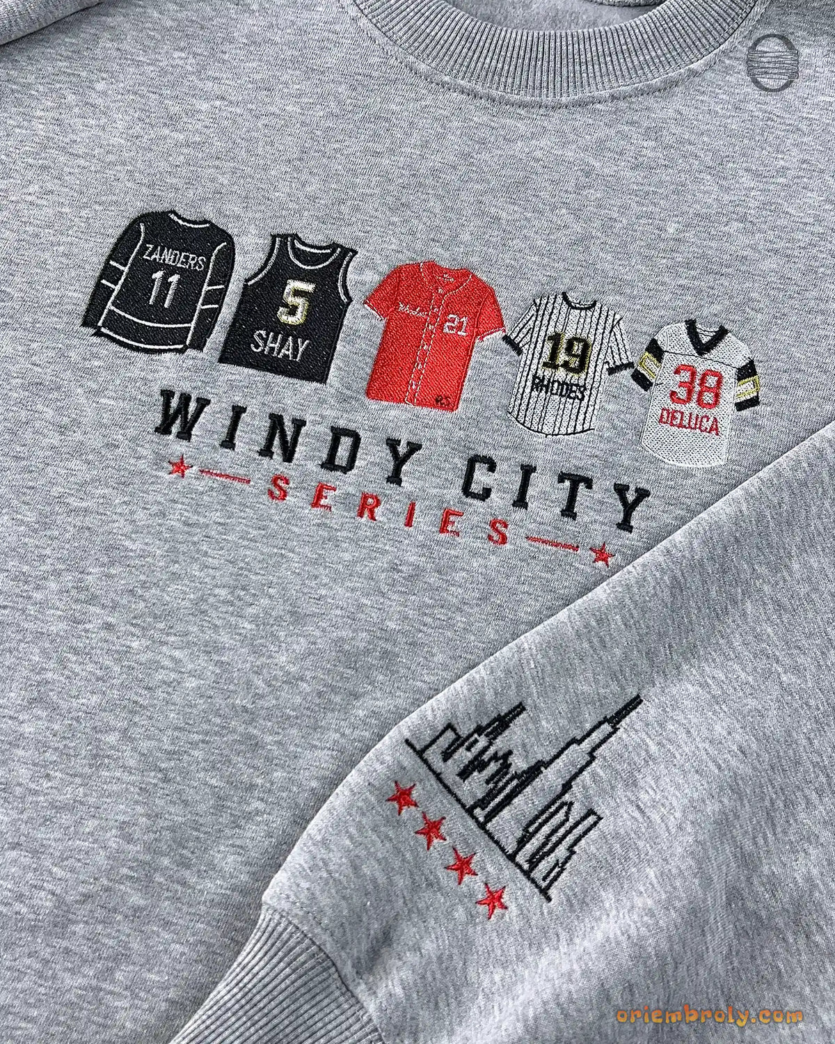 Close-up of Windy City Series text and colorful Chicago sports jerseys embroidery on a grey sweatshirt