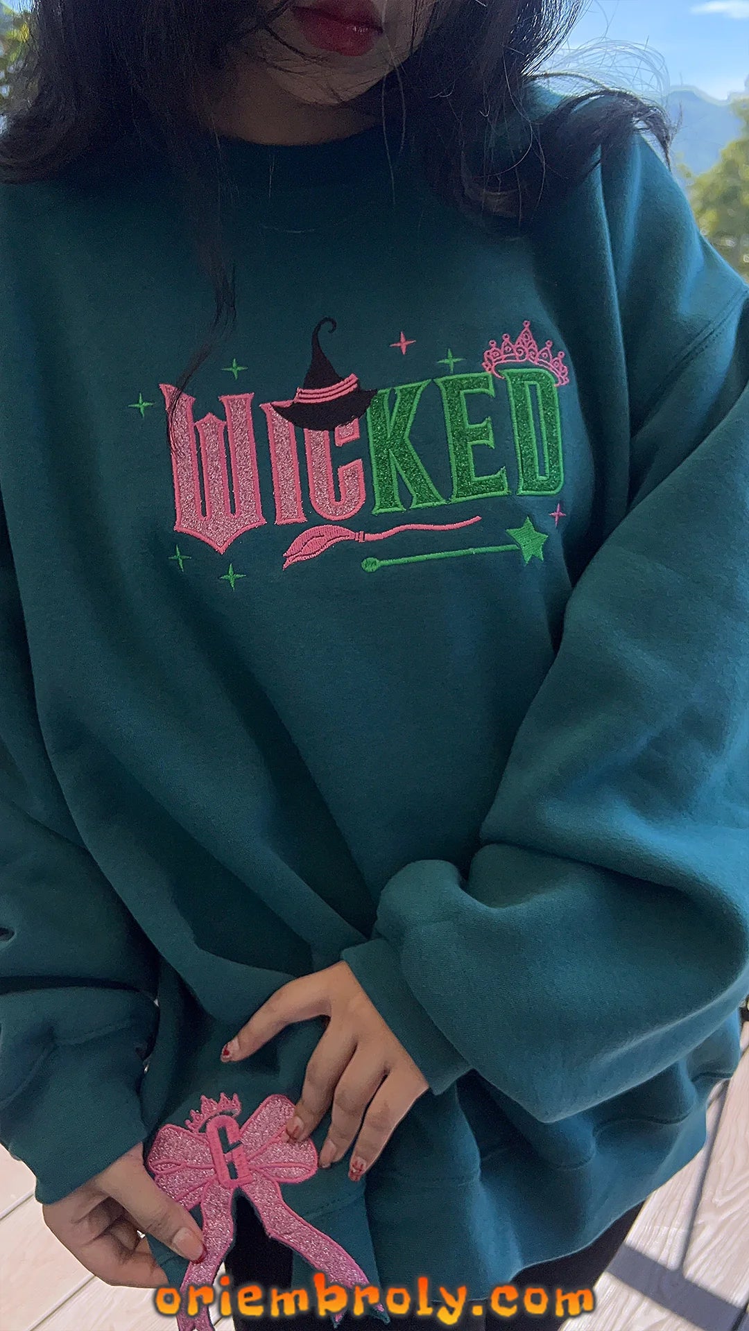 Close-up of whimsical bow embroidery on sweatshirt