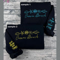 Cousins Beach embroidered sweatshirt displayed on hanger