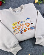 Angled view of cozy light gray La La La Season embroidered pullover sweatshirt with autumn vibes.