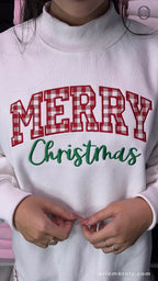 Model wearing a white Merry Christmas red plaid embroidered crewneck sweater
