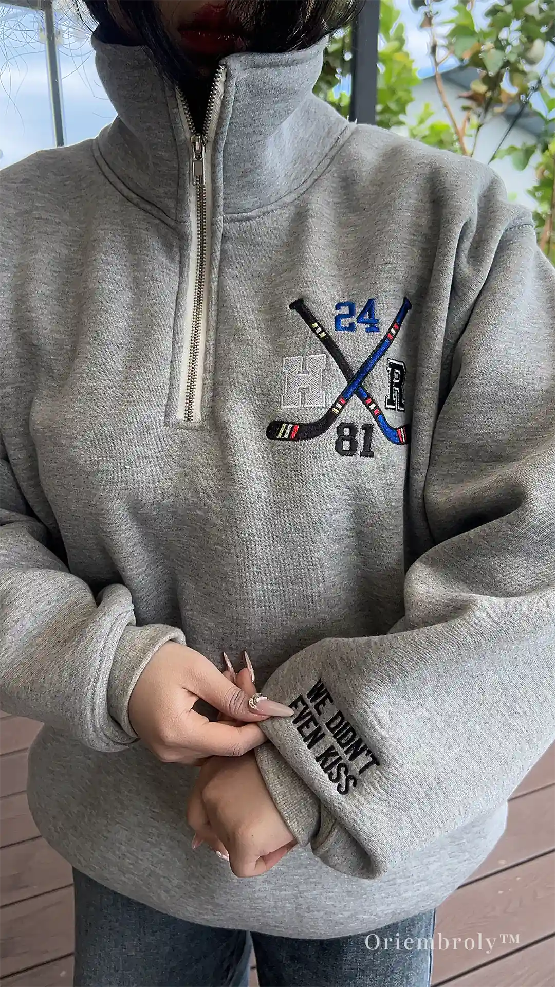 Subtle romance and hockey rivalry detail in pullover