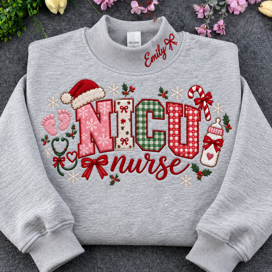 Flat lay of a sport grey crewneck sweatshirt embroidered with Christmas NICU nurse applique letters, santa hat, baby footprints, and custom collar name
