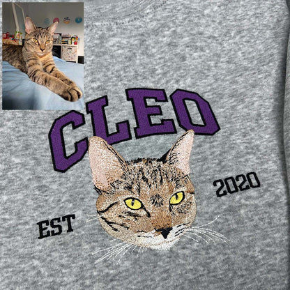 Personalized embroidered sweatshirt featuring a pet’s name.