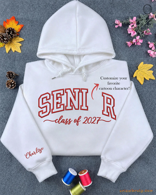 Flatlay view of a white embroidered hoodie with SENIOR Class of 2027 varsity text and custom Spider-Man sleeve name detail.