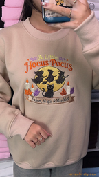 Mirror selfie of model wearing a sand beige A Little Hocus Pocus embroidered crewneck sweater