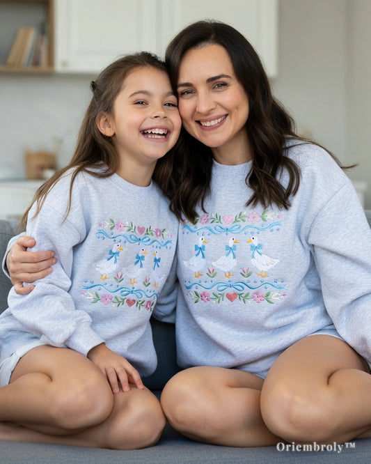 cozy lifestyle shot of cute duck embroidered sweatshirt wearring couple mom and daughter