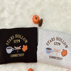 Two pillows with 'Stars Hollow 1779 Connecticut' design on a white surface.