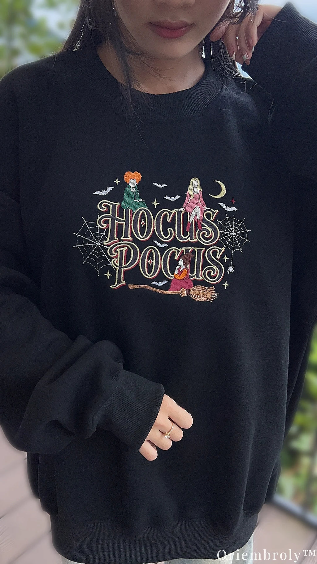 Mirror selfie of model wearing a black oversized Hocus Pocus embroidered crewneck