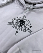 Dense white embroidery stitching on tactical hoodie