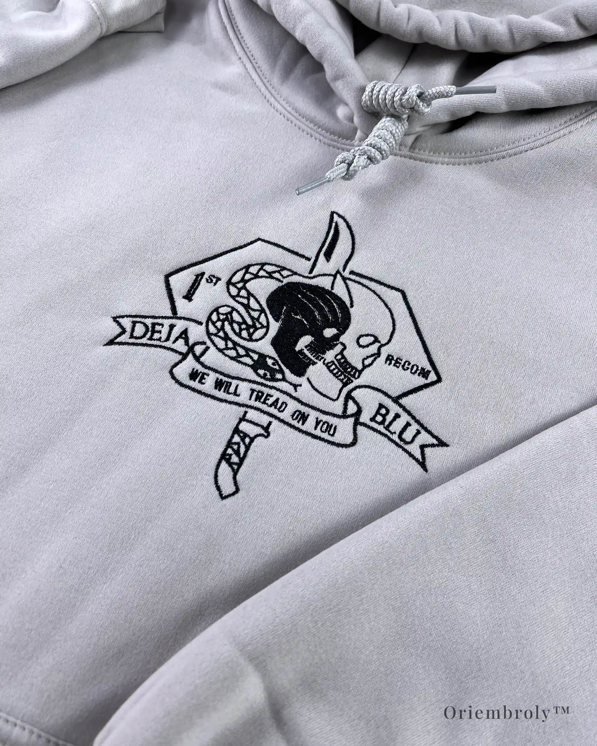 Dense white embroidery stitching on tactical hoodie