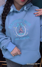 Stylish light blue hoodie with "Happiest Mom on Earth" and a magical castle embroidery. Ideal for a cozy and cute Main Street USA outfit during a Disney vacation