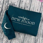 Embroidered New Moon design on black crewneck