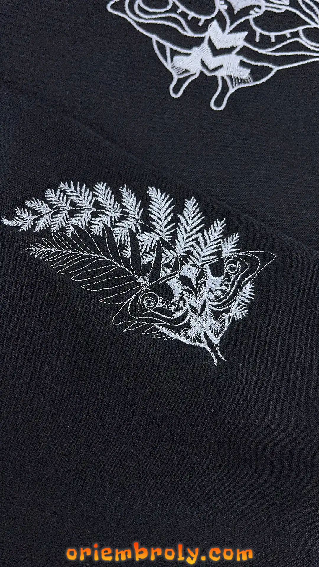 Detailed embroidery of death's-head hawkmoth and skull
