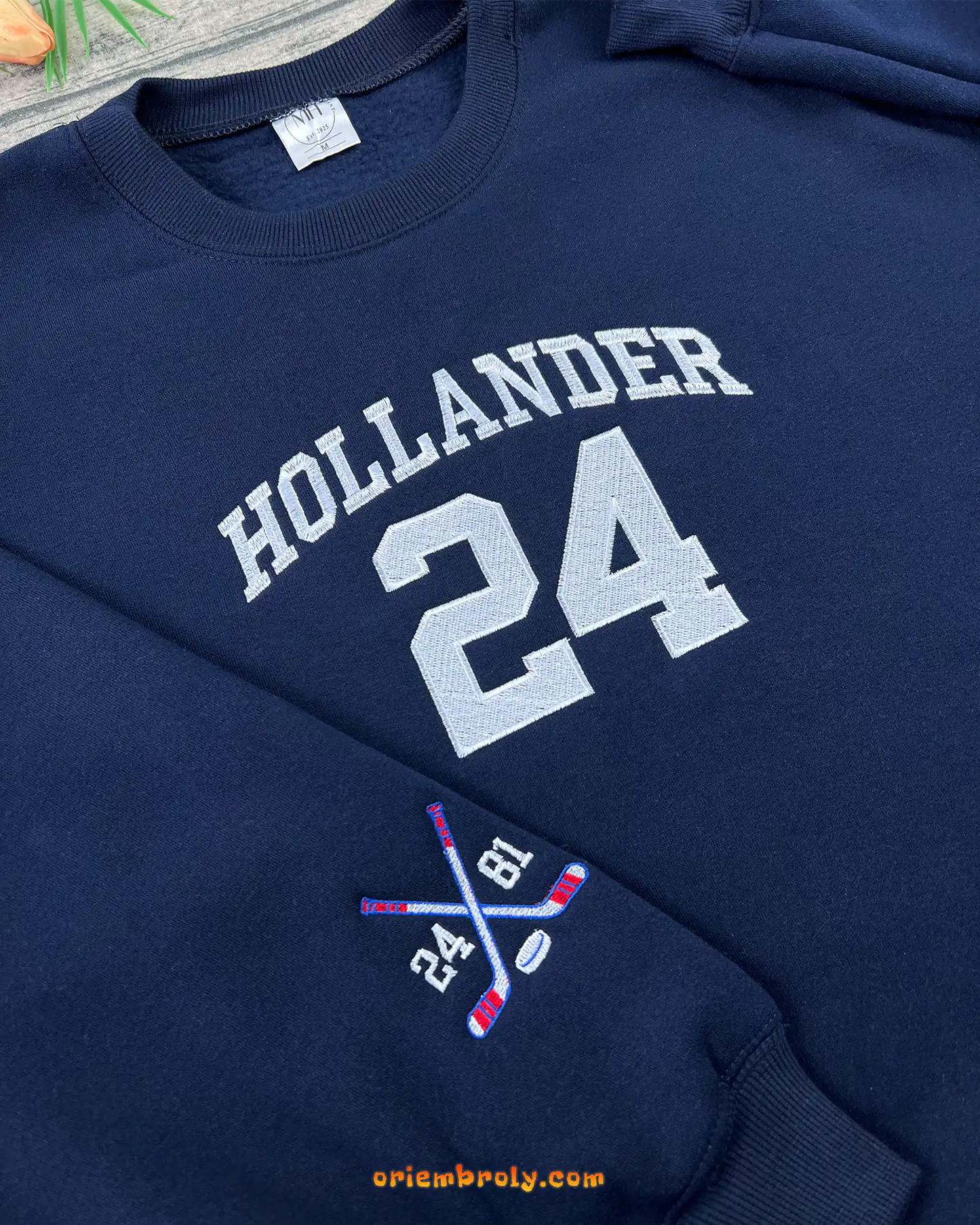 Sleeve embroidery with hockey sticks and puck design