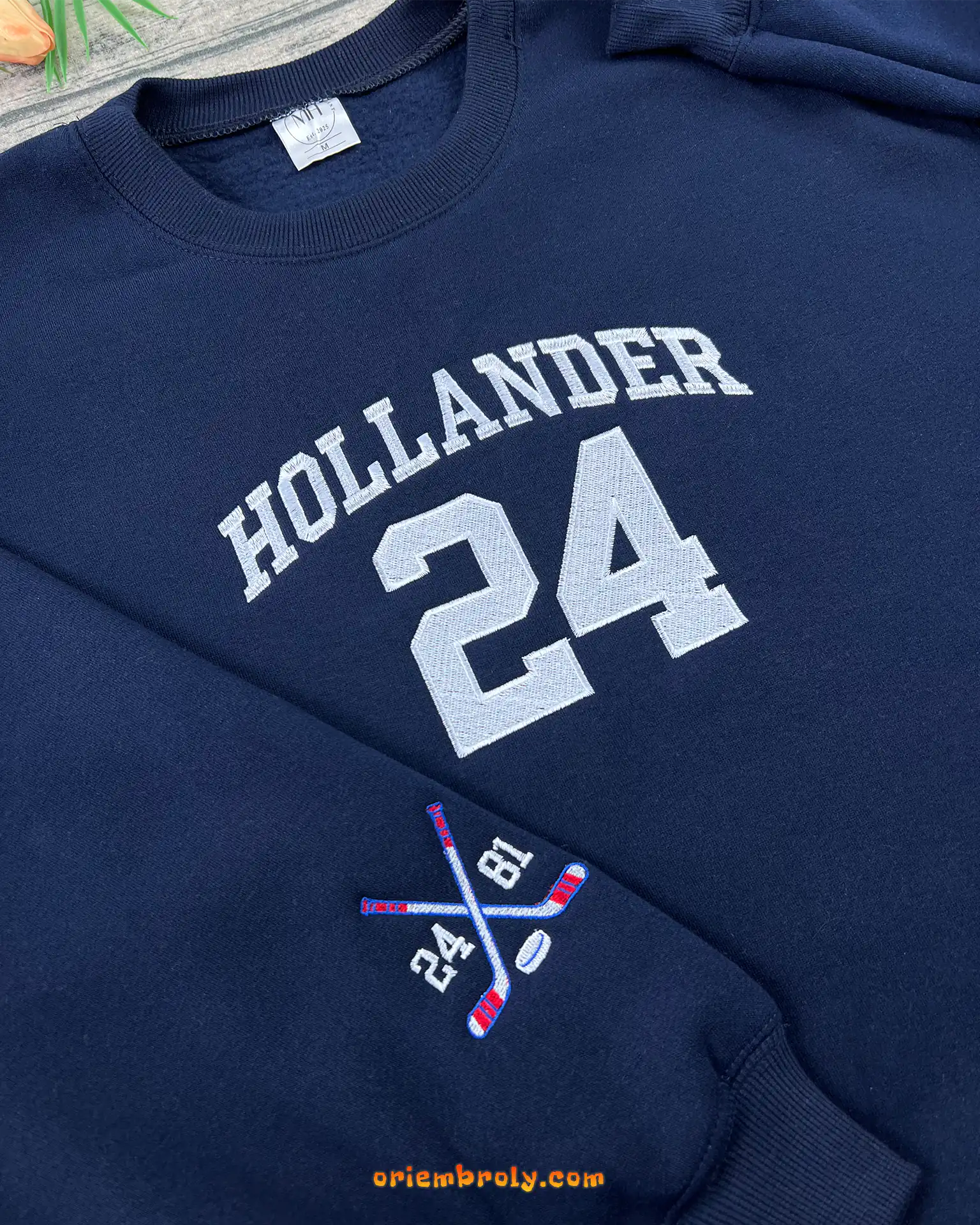 Sleeve embroidery with hockey sticks and puck design