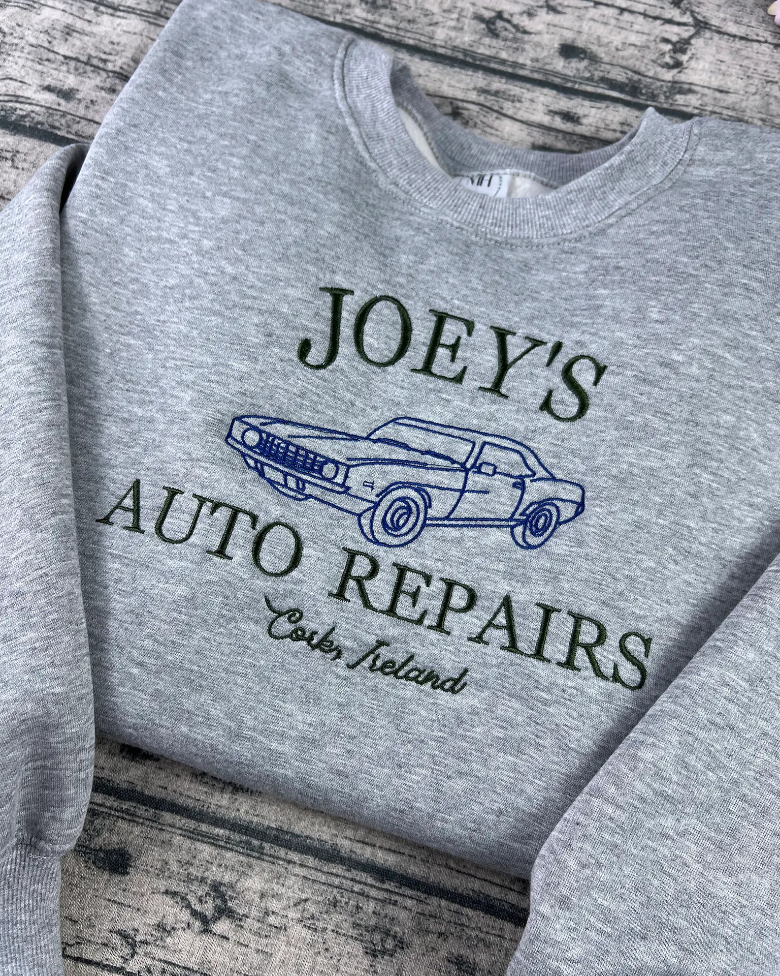 Custom mechanic sweatshirt with embroidered Joey's Auto Repair logo