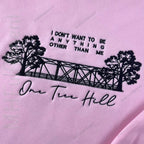 Girl wearing Tree Hill Ravens hoodie outdoors
