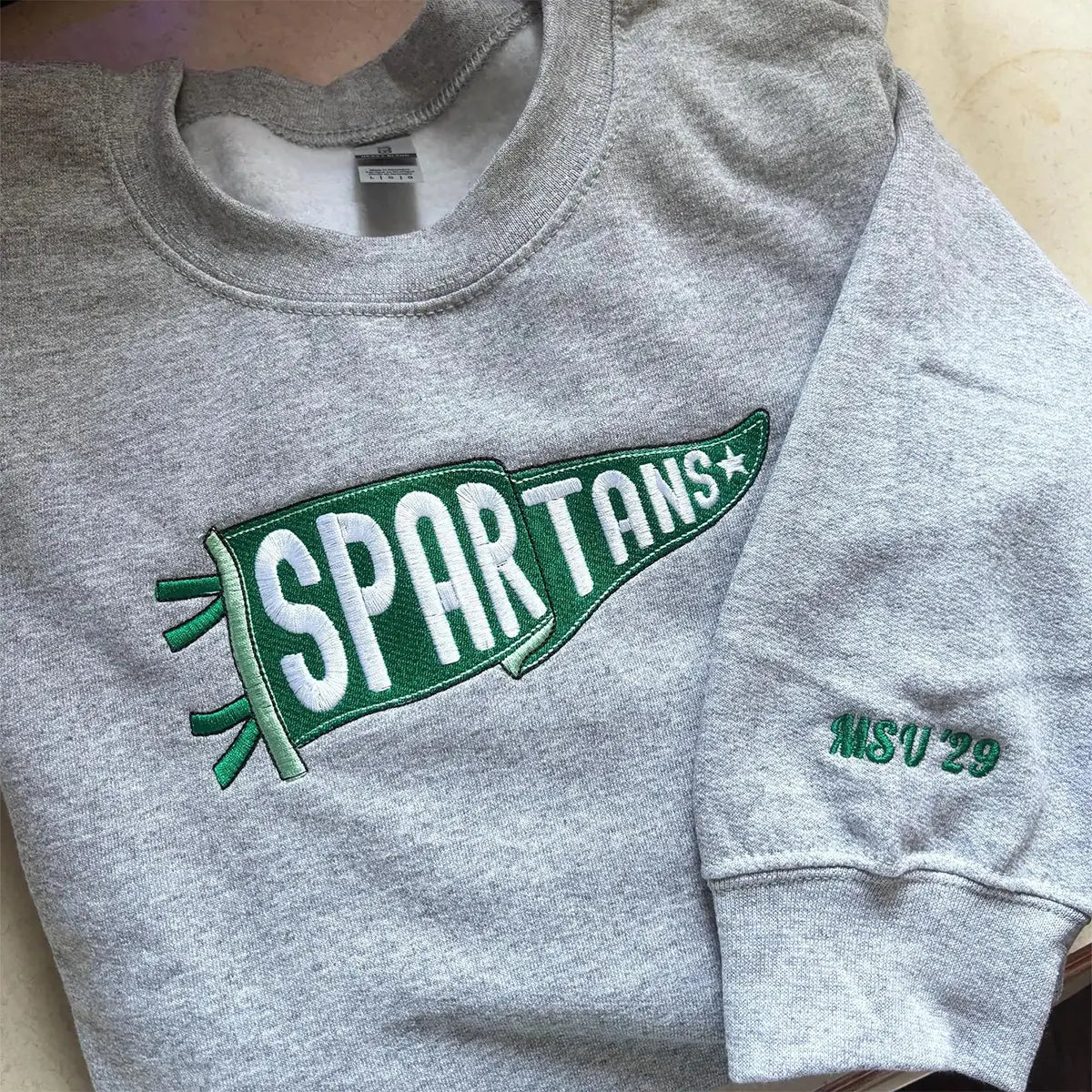 Custom embroidered sweatshirt with team name pennant design