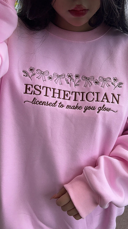 Minimalist esthetician apparel with “licensed to make you glow” design