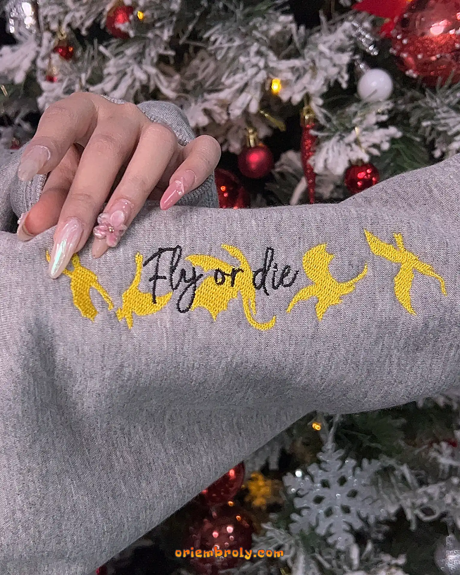 Fly or Die text with yellow dragons on right sleeve embroidery