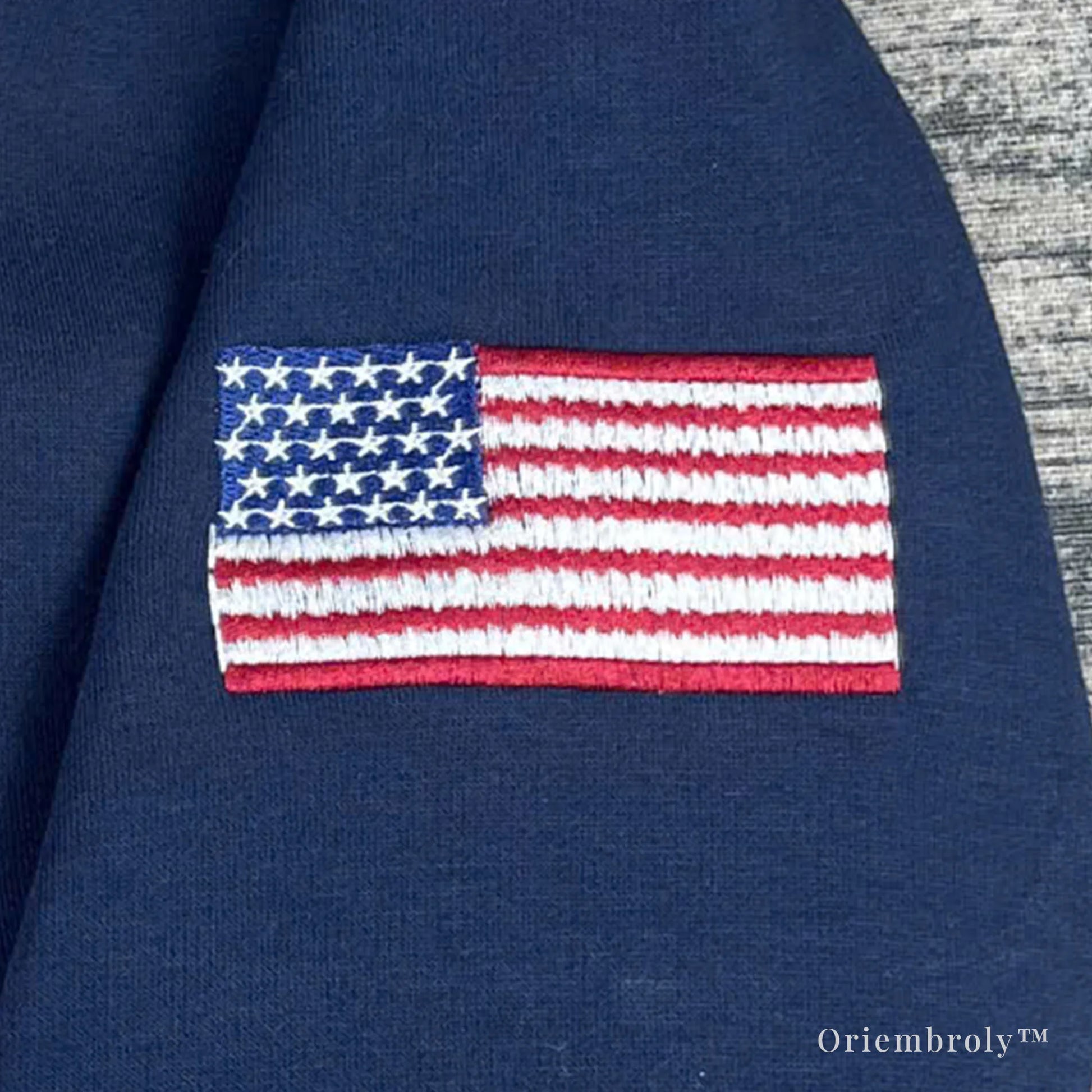 embroidered flag patch on sleeve of quarter zip sweatshirt