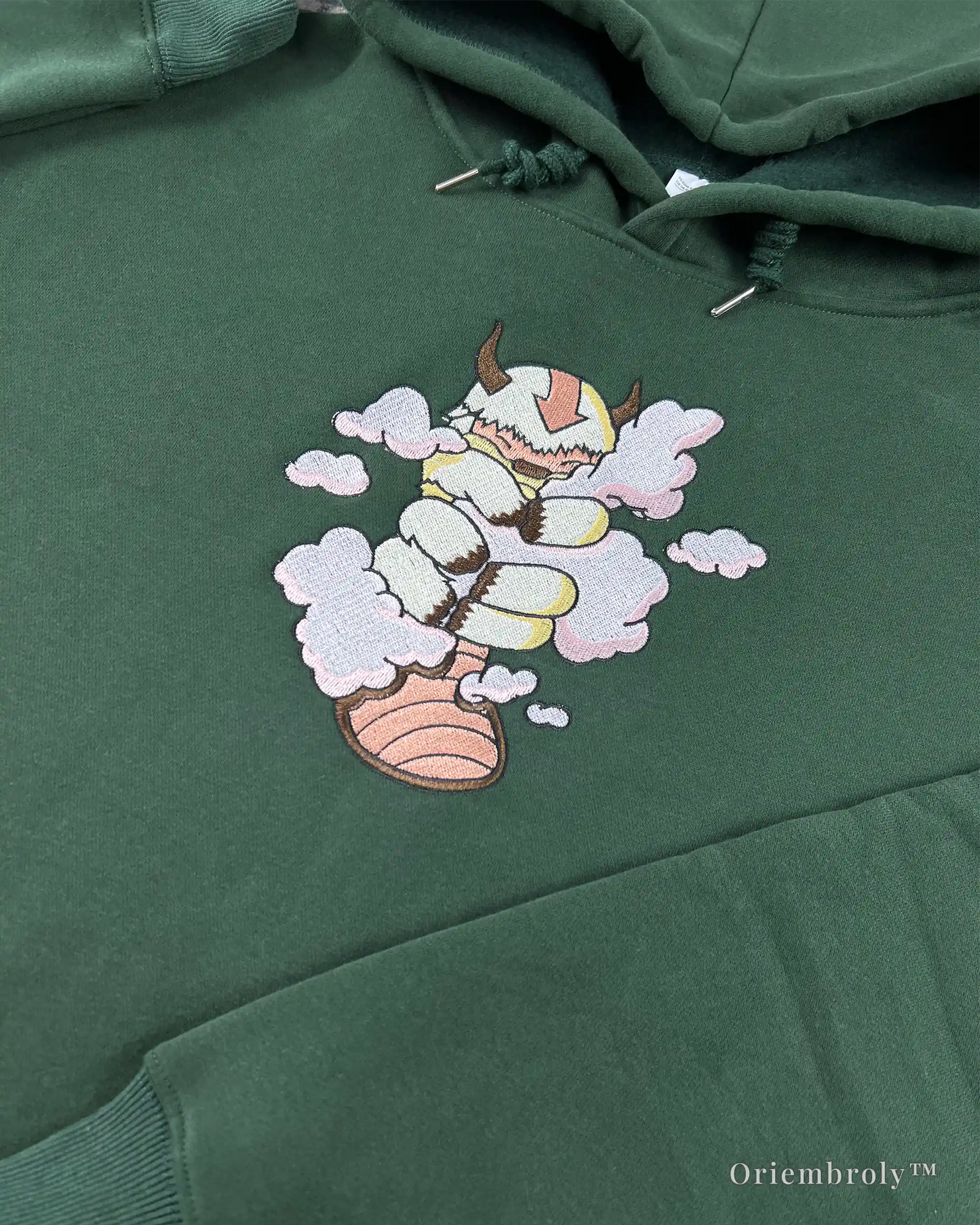 forest green embroidered fantasy hoodie flat lay