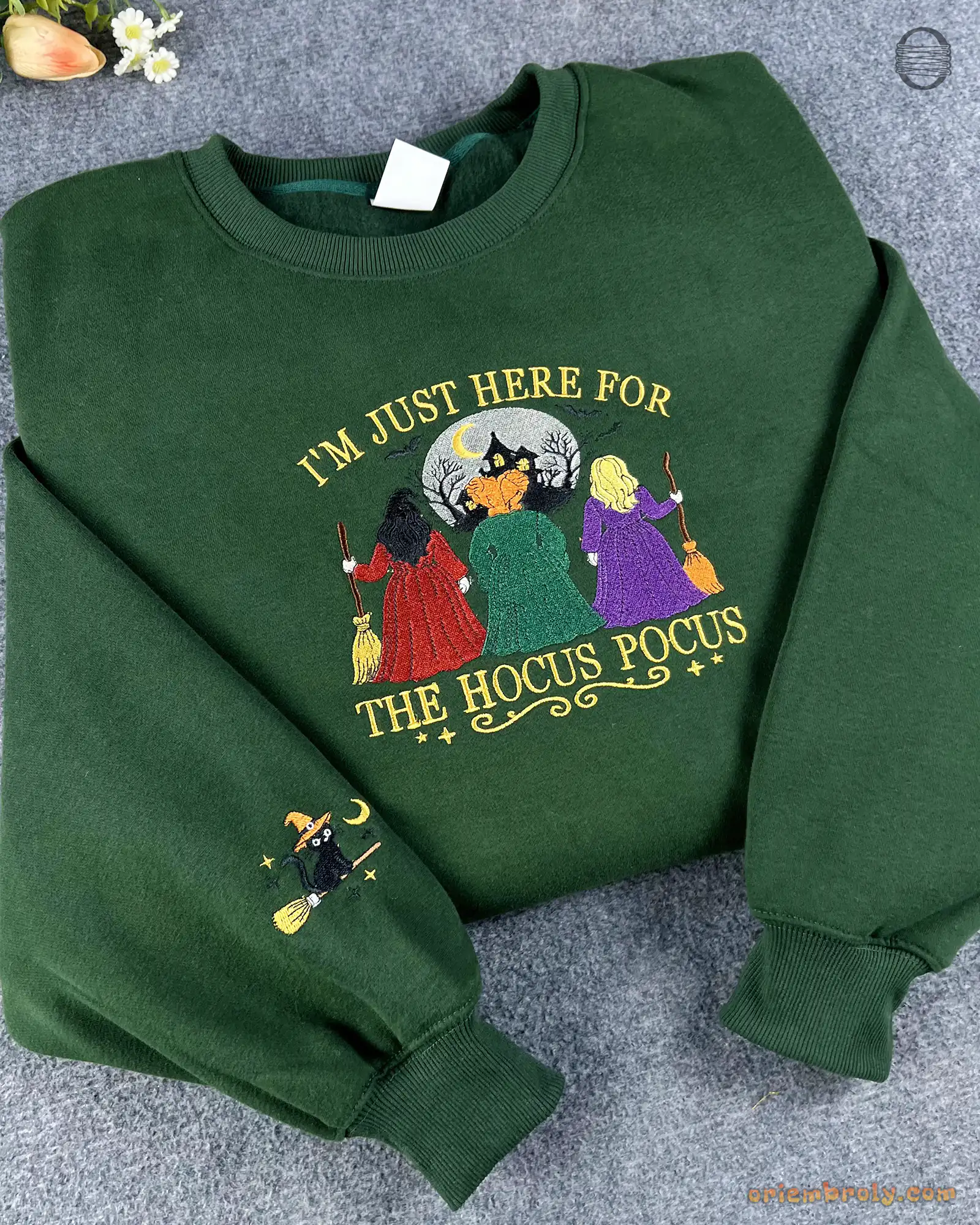 Overview flat lay of a forest green Hocus Pocus embroidered crewneck sweater for spooky season outfit