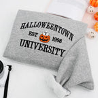 Gray sweatshirt with 'Halloweentown University Est. 1998' text and pumpkin graphic on a white background.
