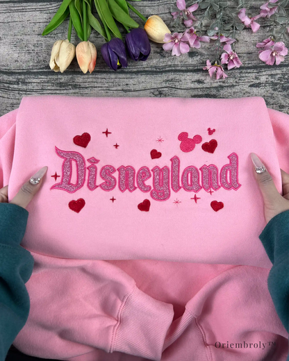 Glitter embroidered pink sweatshirt, perfect for theme park trips, cozy days, and anyone who loves a little sparkle.