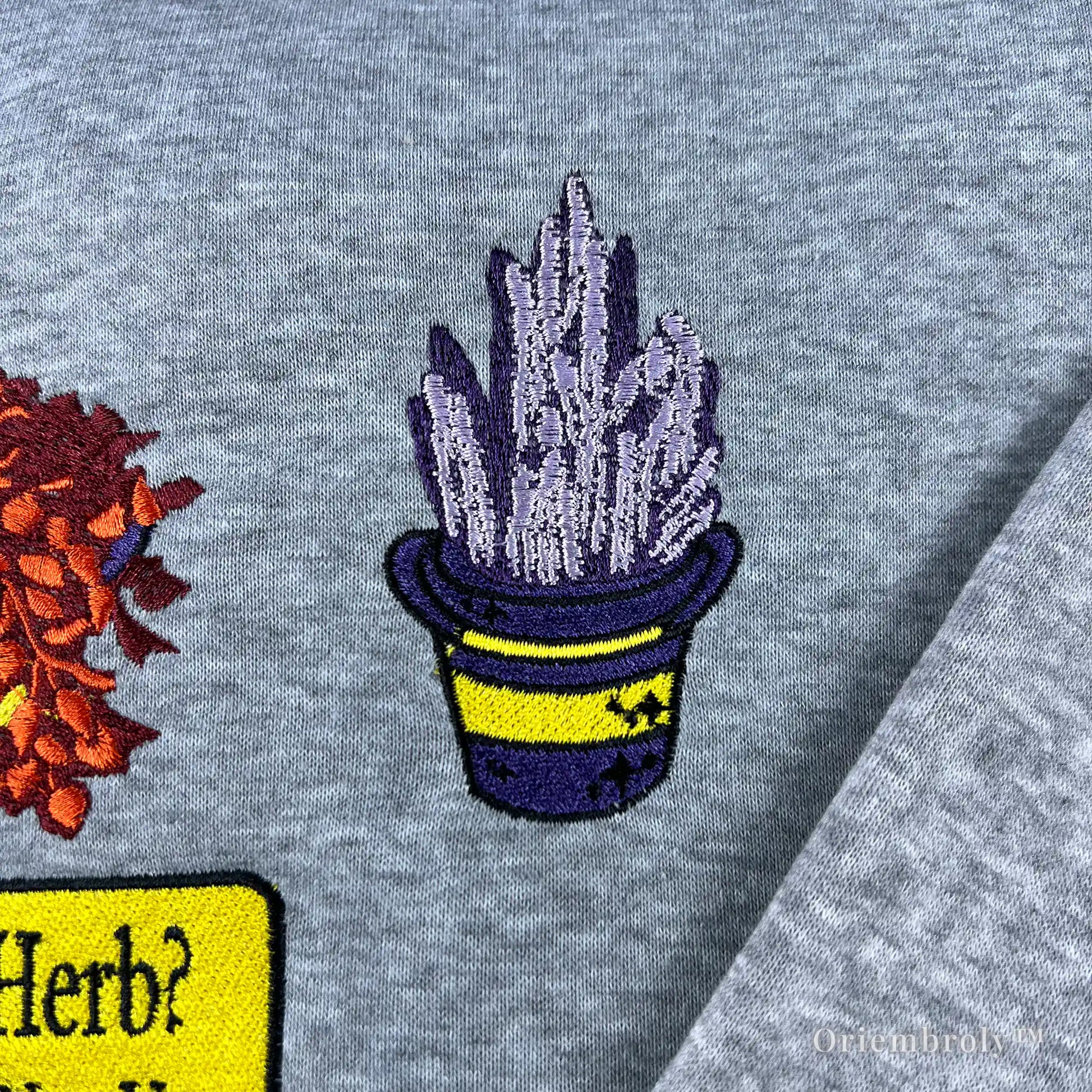 High-quality embroidery of Resident Evil healing herbs on a comfortable grey gaming sweater