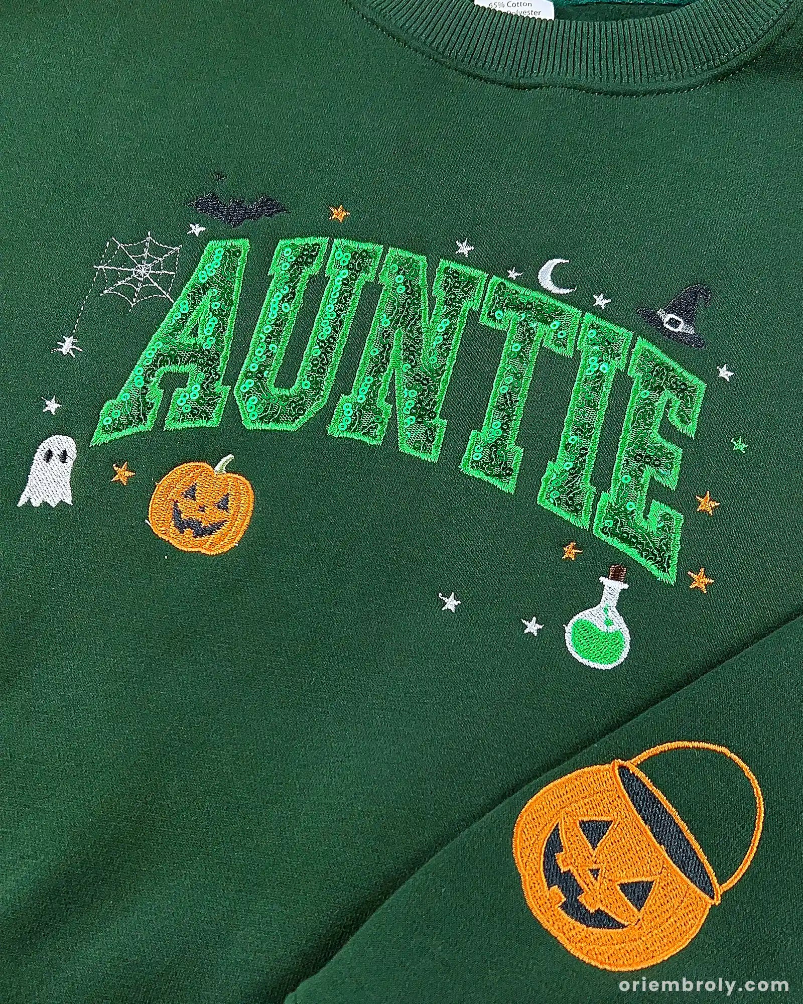 Close-up of green Auntie Halloween sweatshirt with green pattern sequin fill varsity letters, jack-o-lantern pumpkin, and potion bottle design.