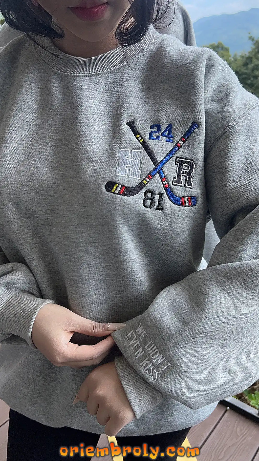 Hockey rivalry pullover with embroidered romance