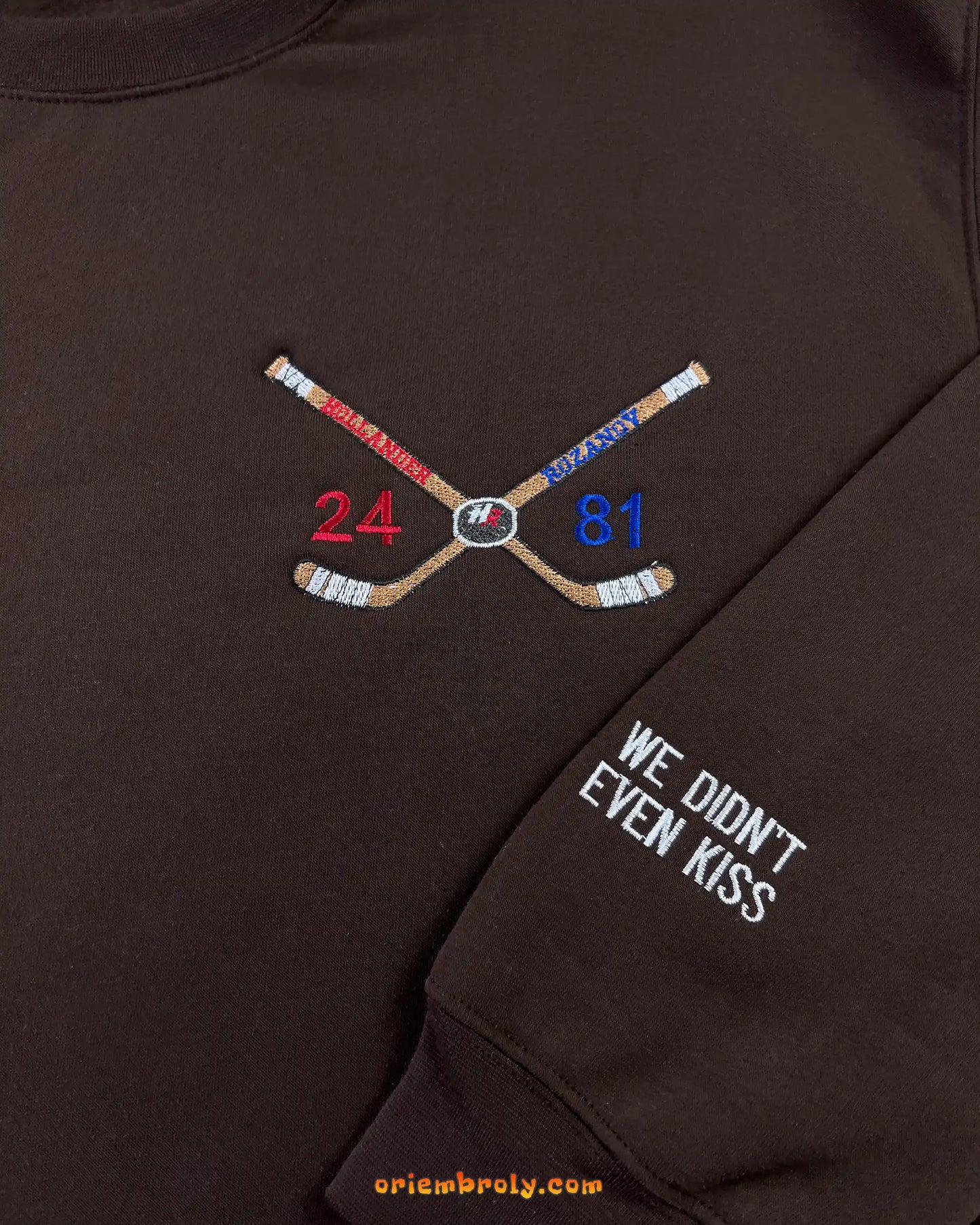 Crossed hockey sticks embroidery with player numbers