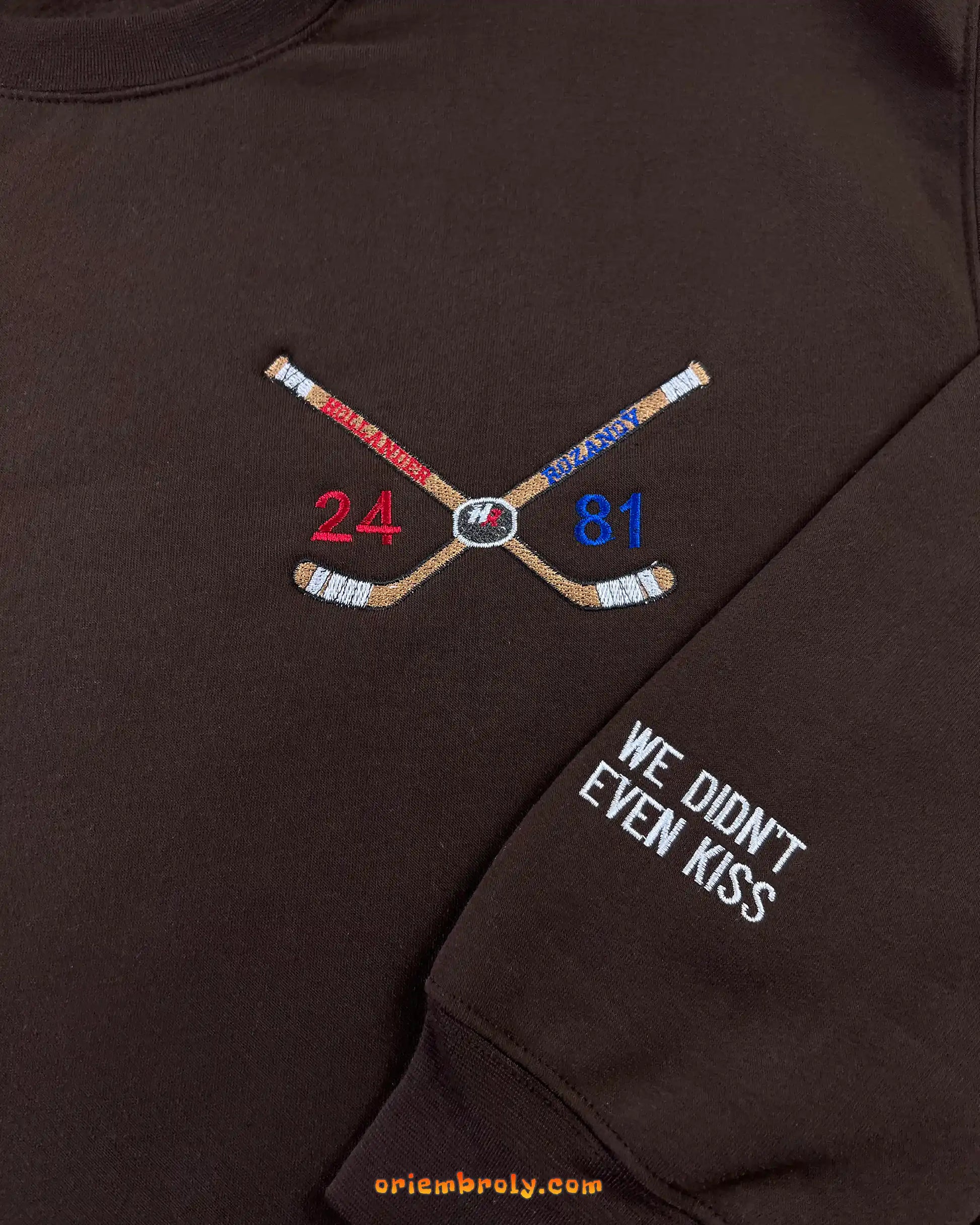 Crossed hockey sticks embroidery with player numbers