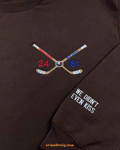 Crossed hockey sticks embroidery with player numbers